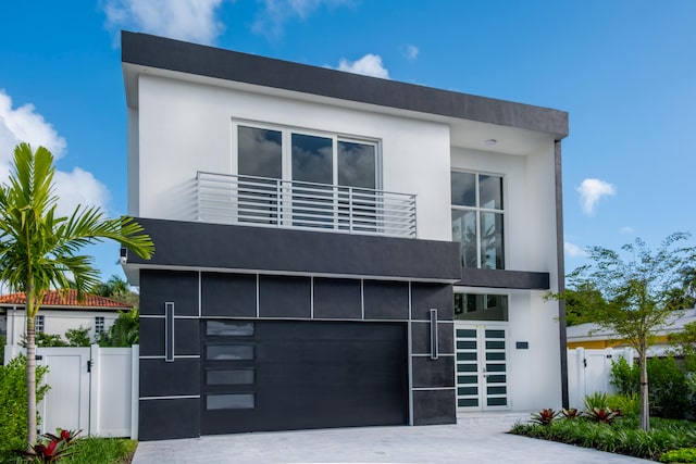 modern home featuring a garage and a balcony