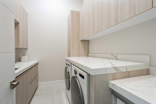 laundry area featuring washer and dryer, baseboards, and cabinet space