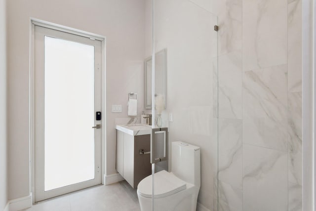 bathroom featuring toilet, vanity, baseboards, and tile patterned flooring