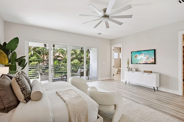 bedroom with access to exterior, light wood-type flooring, baseboards, ceiling fan, and ensuite bath