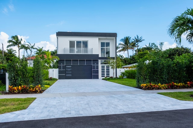 modern home with a balcony and a garage