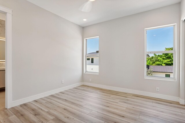 unfurnished room featuring light wood-type flooring, ceiling fan, baseboards, and recessed lighting