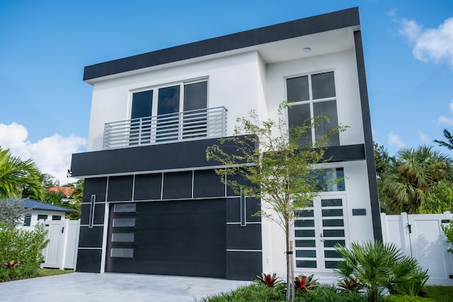 contemporary home with a garage and a balcony