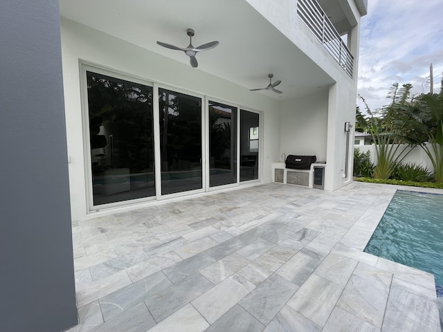view of patio with a ceiling fan, area for grilling, and fence