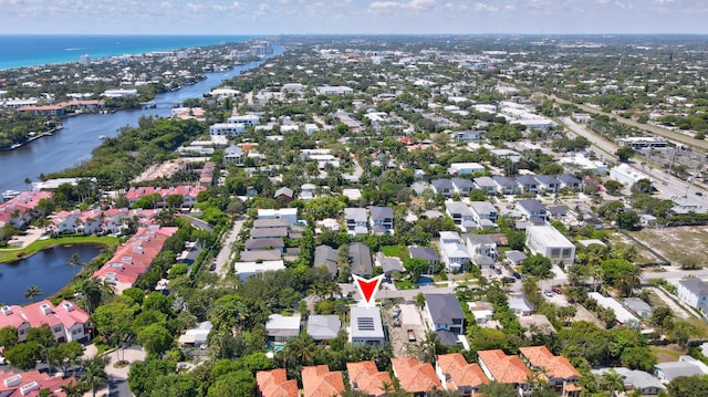 aerial view of property and surrounding area with a nearby body of water and nearby suburban area