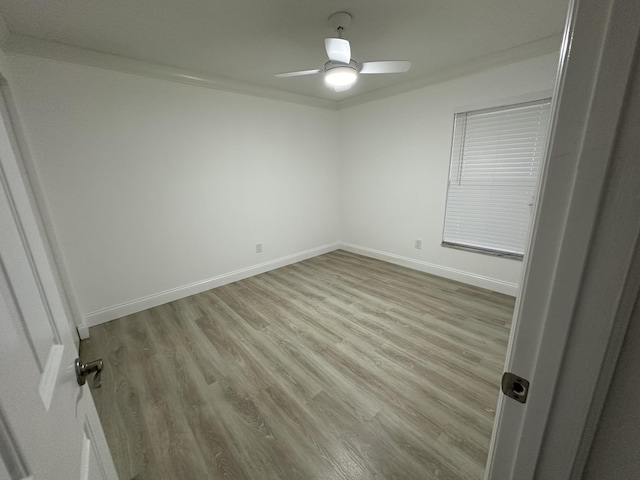 empty room featuring ceiling fan, light hardwood / wood-style flooring, and crown molding