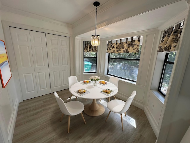 dining area with a chandelier, crown molding, and dark hardwood / wood-style flooring