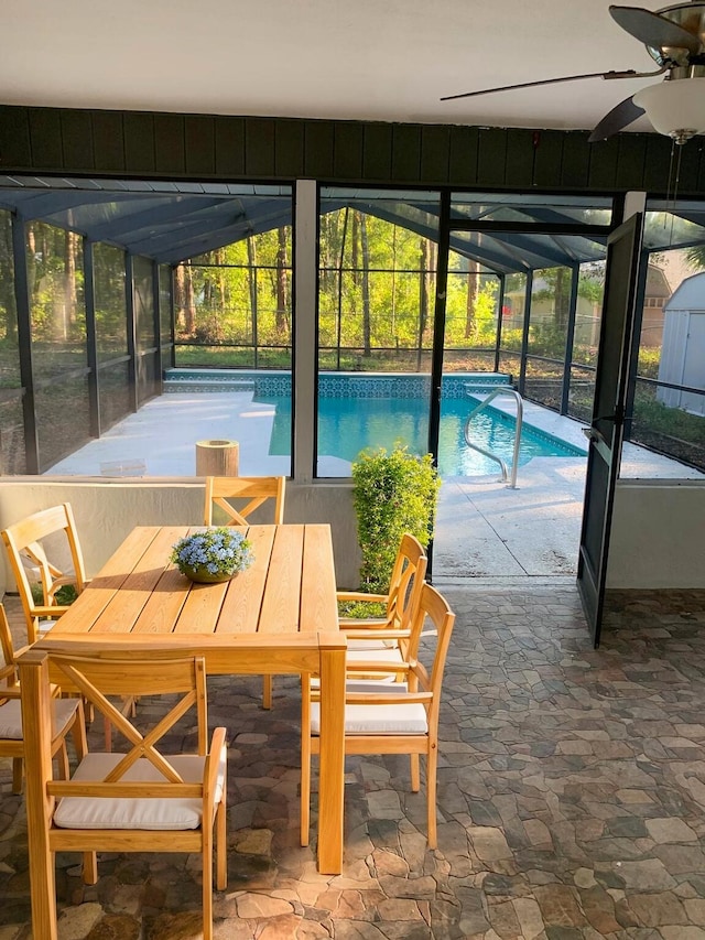 view of pool featuring ceiling fan, a lanai, and a patio