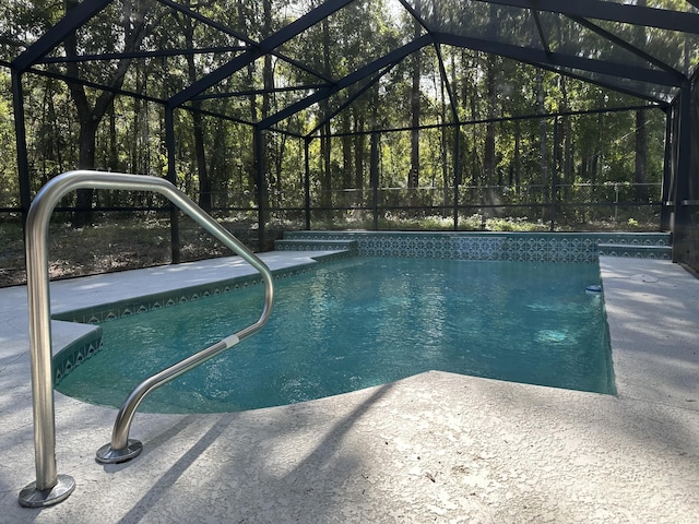 view of swimming pool with a lanai and a patio area