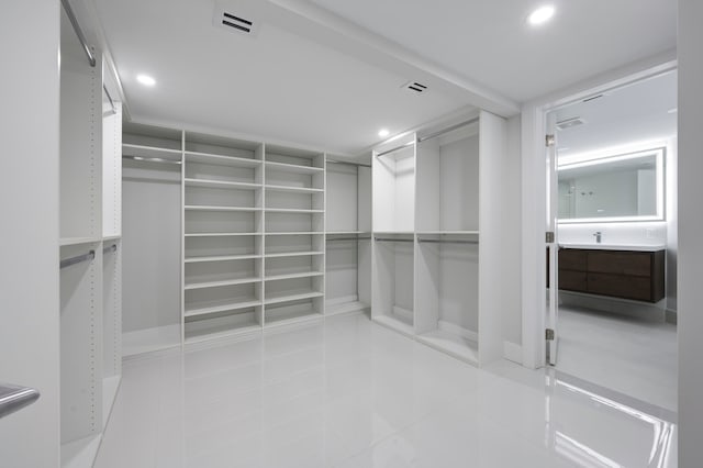 walk in closet with tile patterned floors