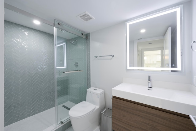 bathroom featuring toilet, an enclosed shower, and vanity