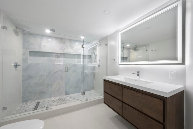 bathroom with vanity, a shower with shower door, and toilet