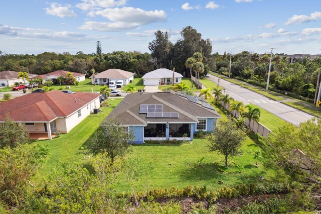 ranch-style home featuring a garage and a front lawn