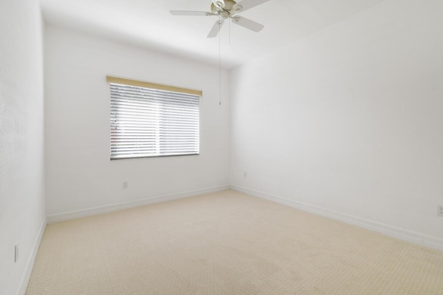 unfurnished room featuring ceiling fan and light colored carpet