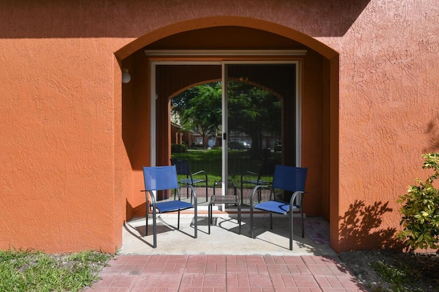 doorway to property with a patio area