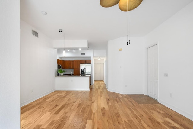 unfurnished living room featuring light hardwood / wood-style flooring and ceiling fan