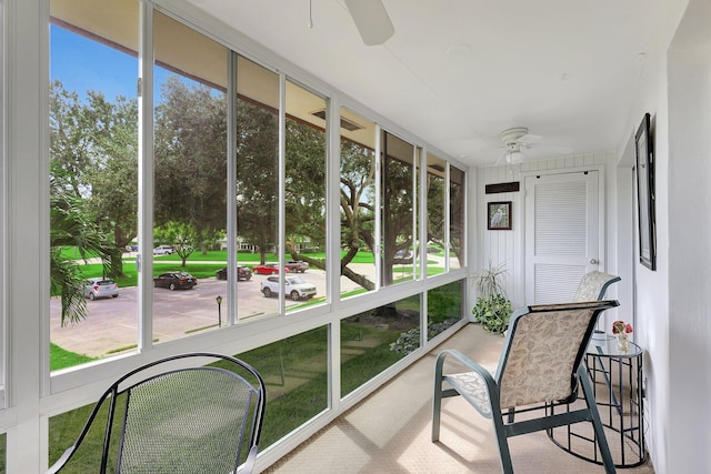 sunroom / solarium featuring ceiling fan