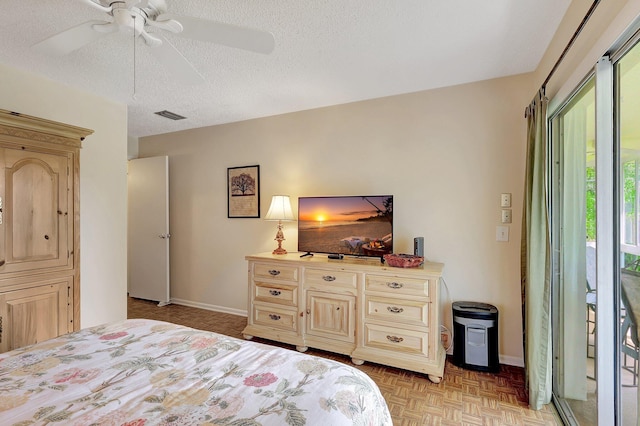 bedroom with ceiling fan, light parquet flooring, a textured ceiling, and access to exterior