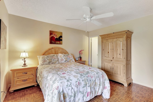 bedroom featuring ceiling fan, a textured ceiling, and dark parquet flooring