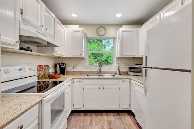 kitchen with sink, white cabinetry, light wood-type flooring, and white appliances