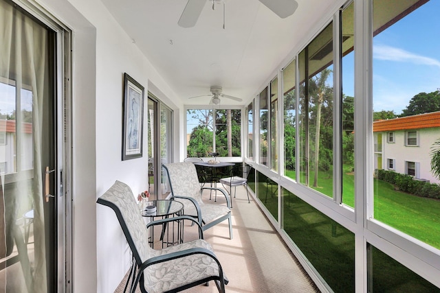 sunroom / solarium featuring ceiling fan and a wealth of natural light