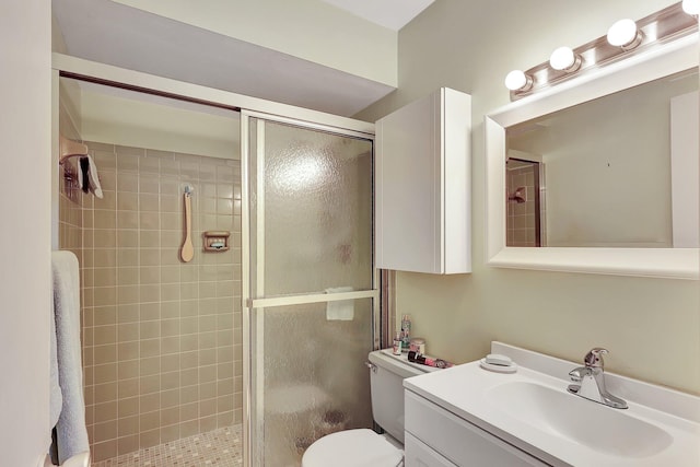 bathroom with vanity, toilet, and an enclosed shower