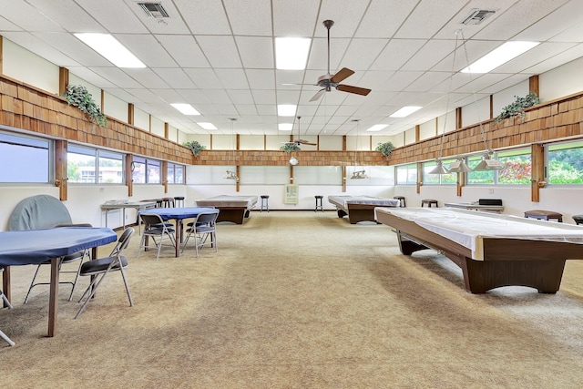 rec room featuring a drop ceiling, carpet flooring, and ceiling fan