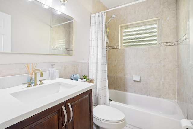 full bathroom featuring vanity, toilet, shower / bathtub combination with curtain, and tile walls