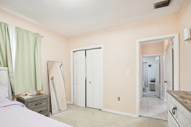 bedroom with a closet and light carpet