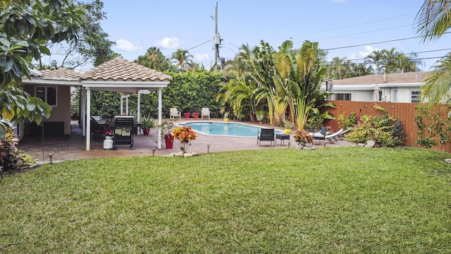 view of swimming pool featuring a yard and a patio area