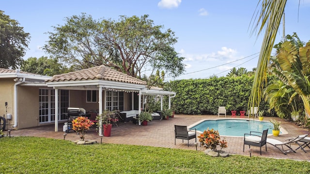 view of pool with a yard and a patio area