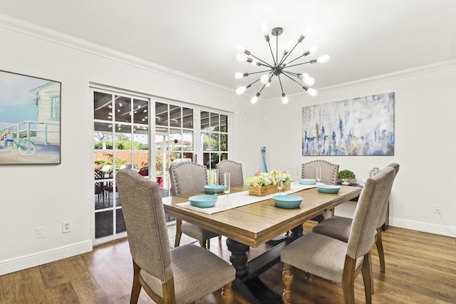 dining space with ornamental molding, hardwood / wood-style floors, and a notable chandelier