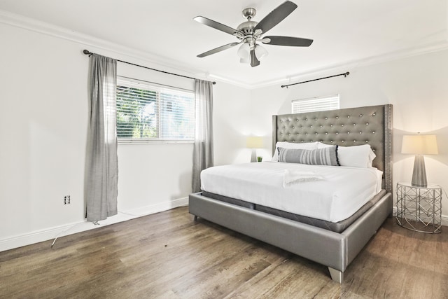 bedroom featuring crown molding, ceiling fan, and dark hardwood / wood-style flooring