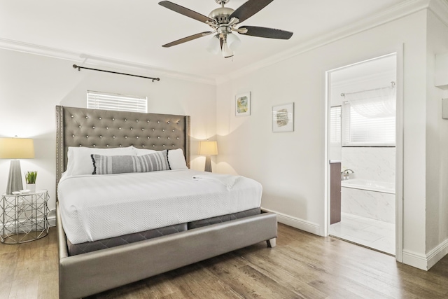 bedroom with crown molding, ensuite bath, ceiling fan, and hardwood / wood-style flooring