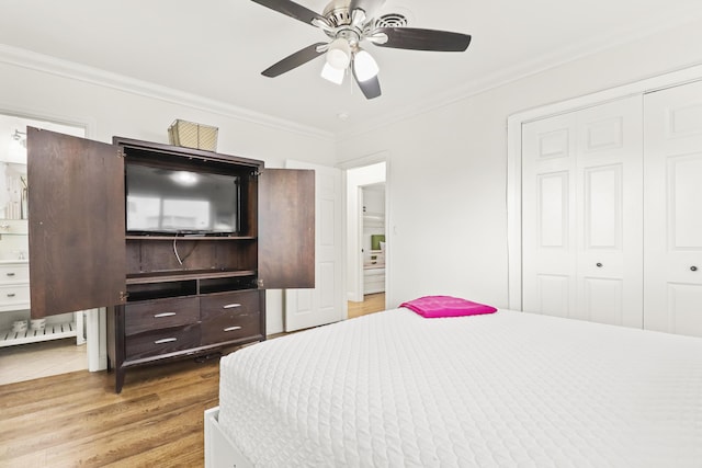 bedroom featuring ornamental molding, wood-type flooring, and a closet