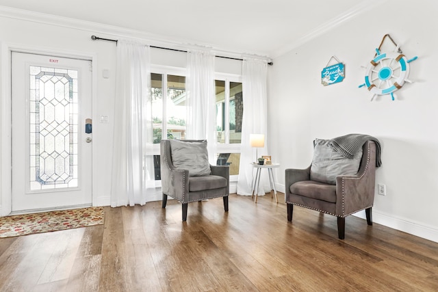 interior space with hardwood / wood-style flooring and crown molding