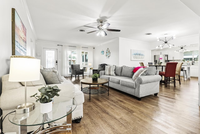 living room with ornamental molding, wood-type flooring, and sink