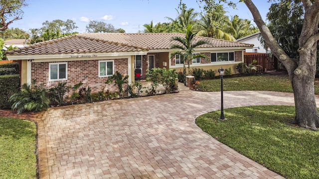 ranch-style home with a front yard