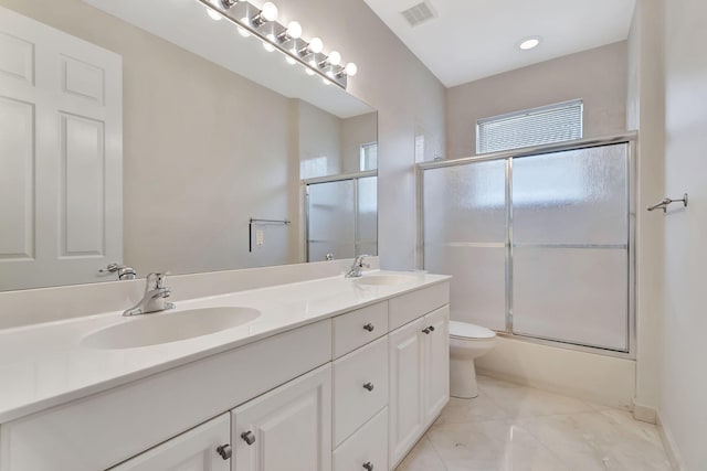 full bathroom with vanity, enclosed tub / shower combo, and toilet