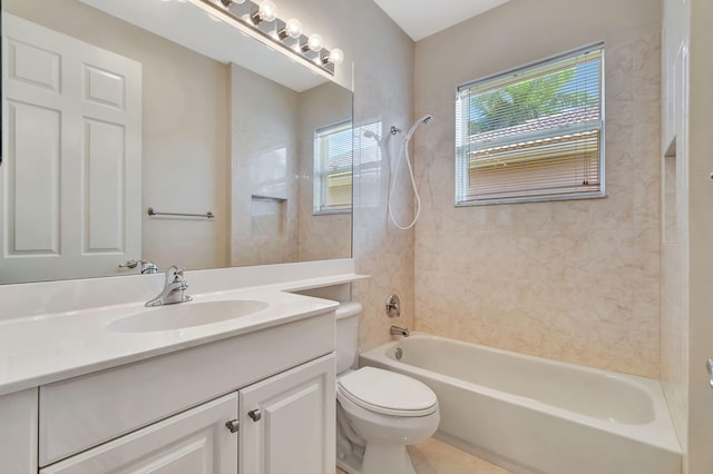 full bathroom featuring toilet, tiled shower / bath, and vanity