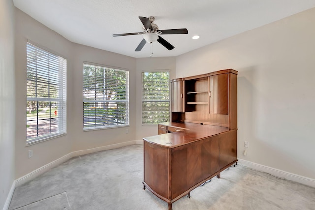 office space with light colored carpet and ceiling fan