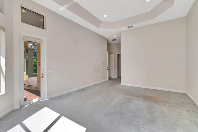 spare room featuring a raised ceiling