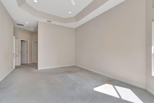 spare room featuring a tray ceiling