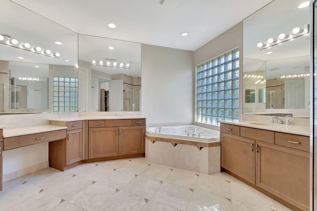 bathroom with vanity and independent shower and bath