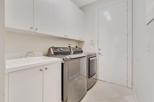 laundry room with washing machine and dryer and cabinets