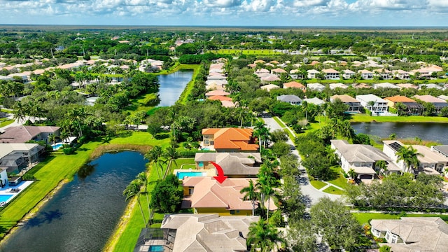 birds eye view of property with a water view