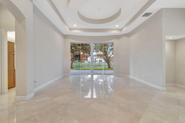 spare room featuring a tray ceiling