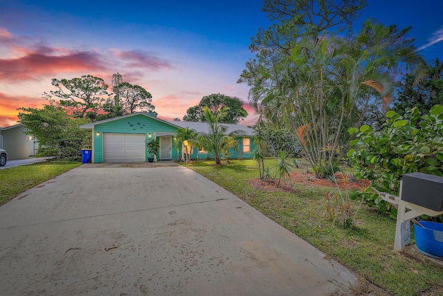 view of front facade with a yard and a garage