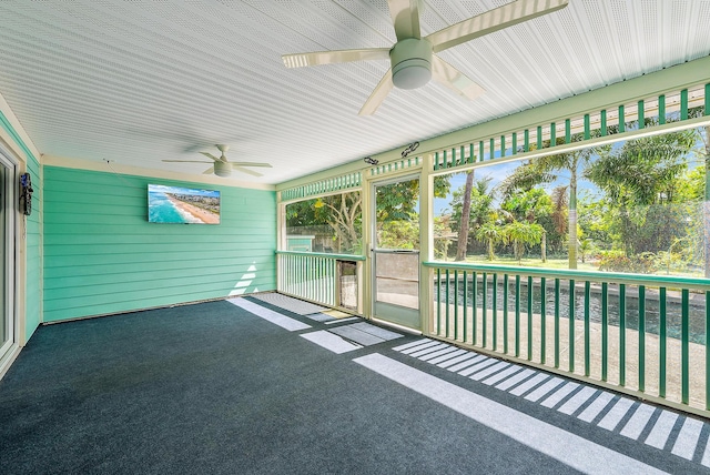 unfurnished sunroom featuring ceiling fan