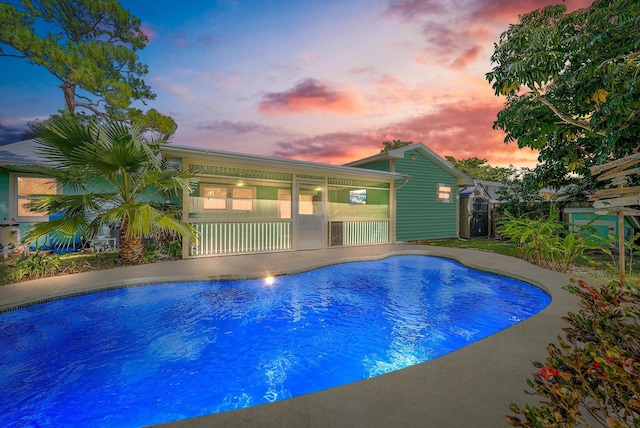 view of pool at dusk